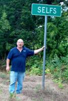 Paul standing by the Selfs, TX sign